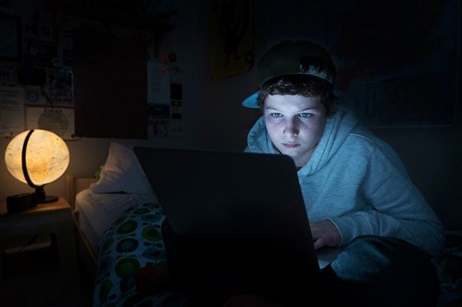 Teen working on laptop